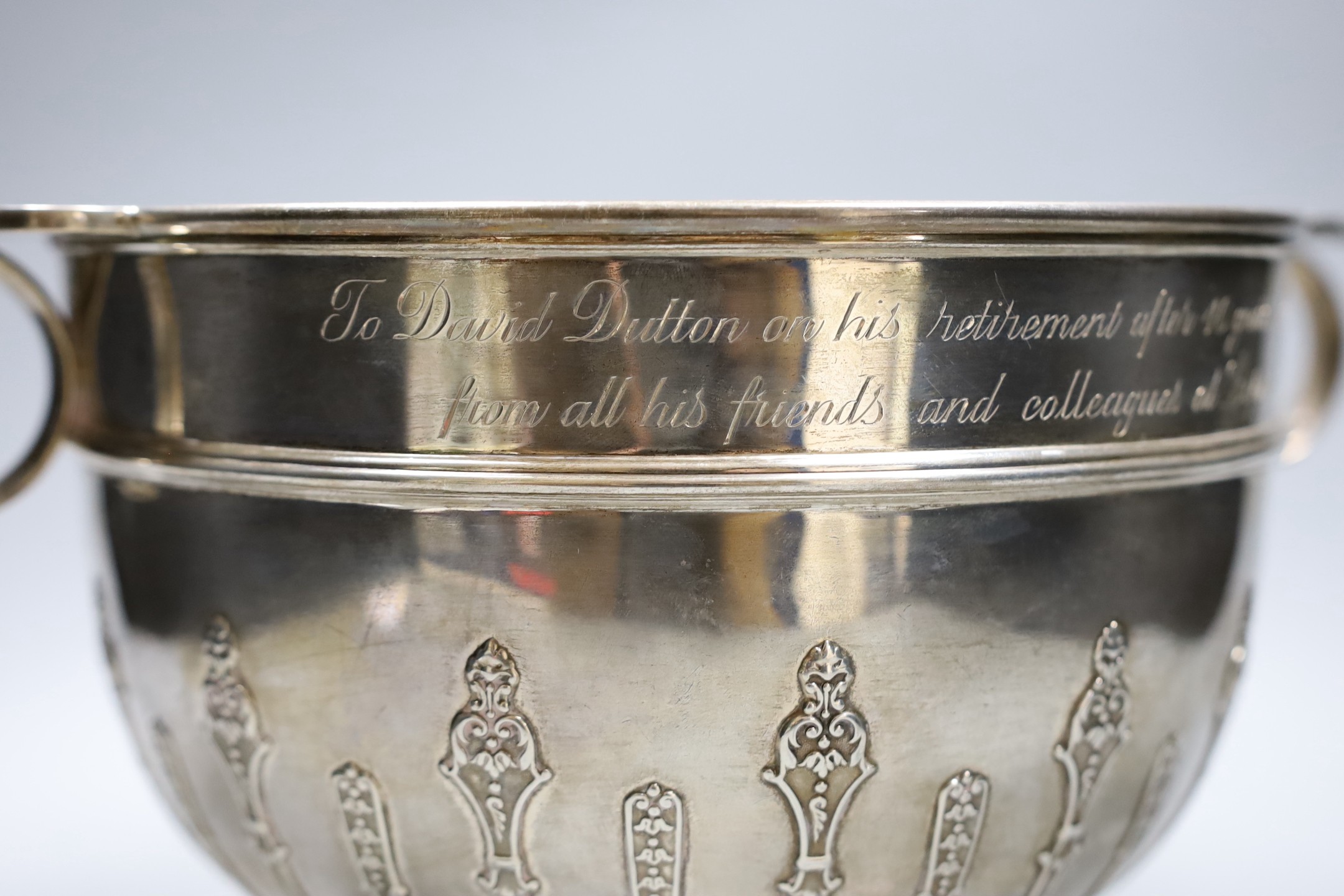 A late Victorian two handled silver rose bowl, with strapwork decoration and later presentation inscription, London 1900, 1532 grams, 35cm over handles, height 18cm